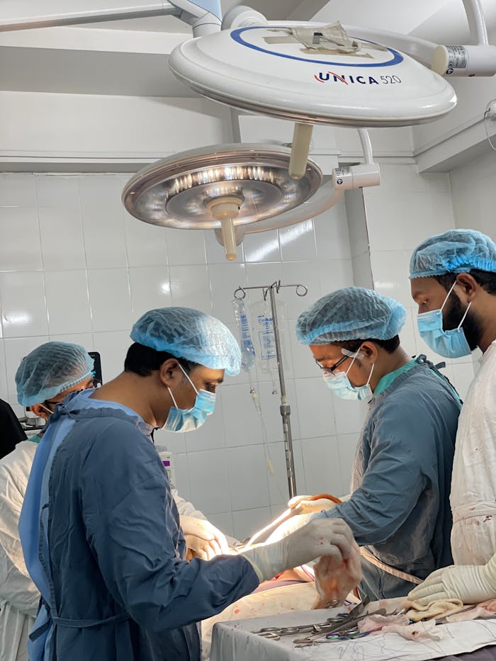 Services-01 Medical professionals conduct surgery in a sterile OR in Dhaka, Bangladesh.